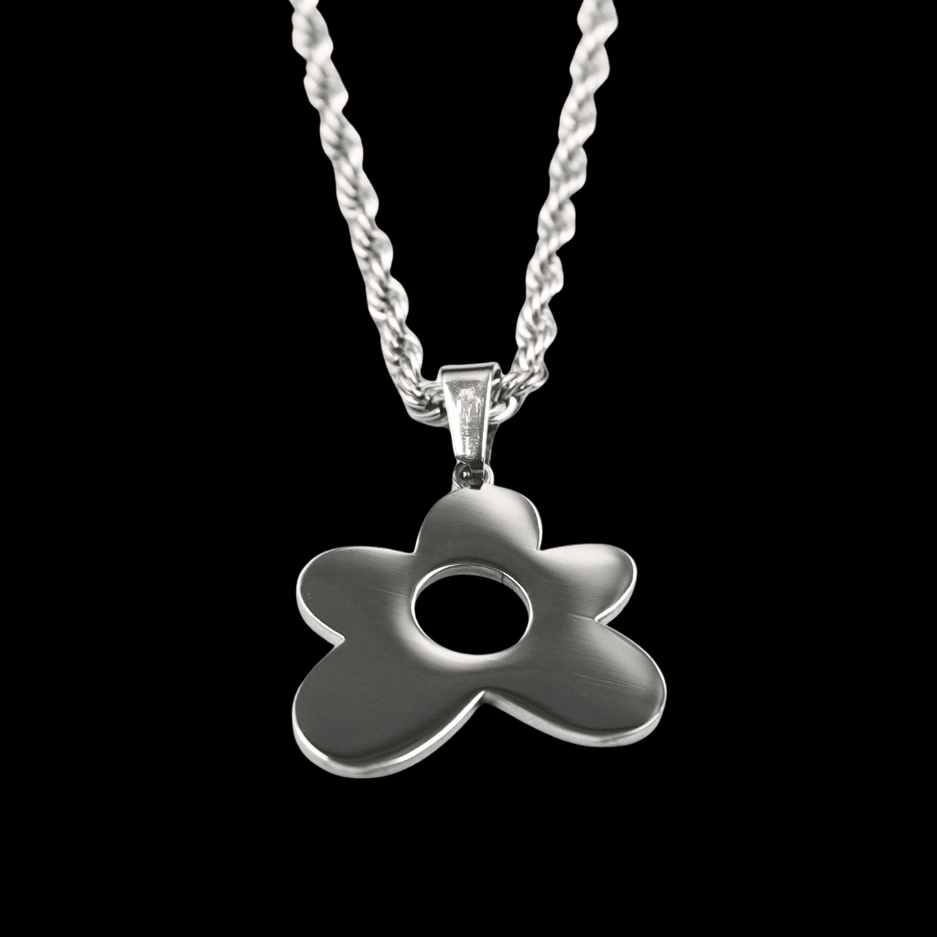 Silver flower-shaped pendant on a black background