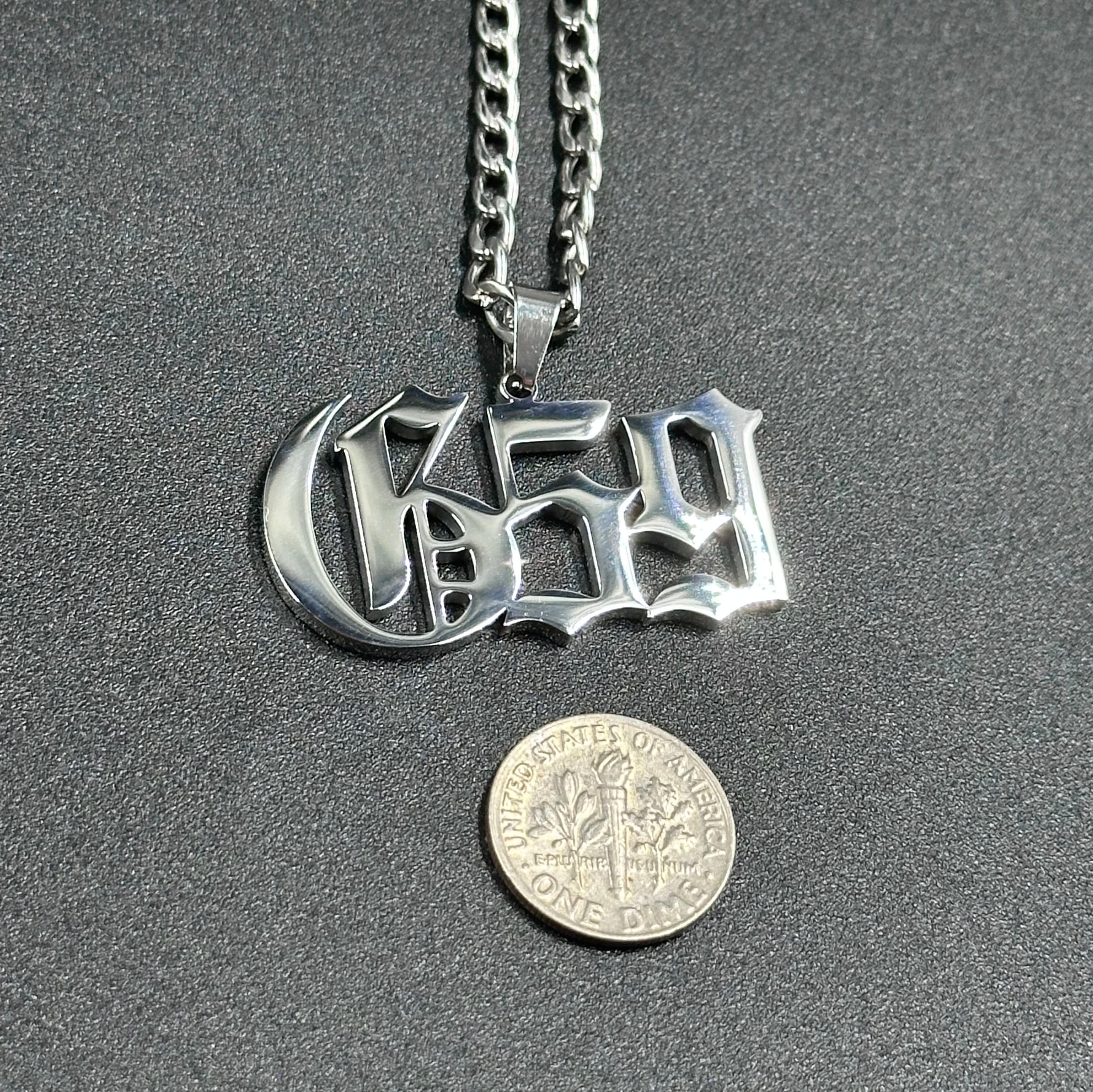 $uicideboy$ G59 pendant beside a US dime for scale