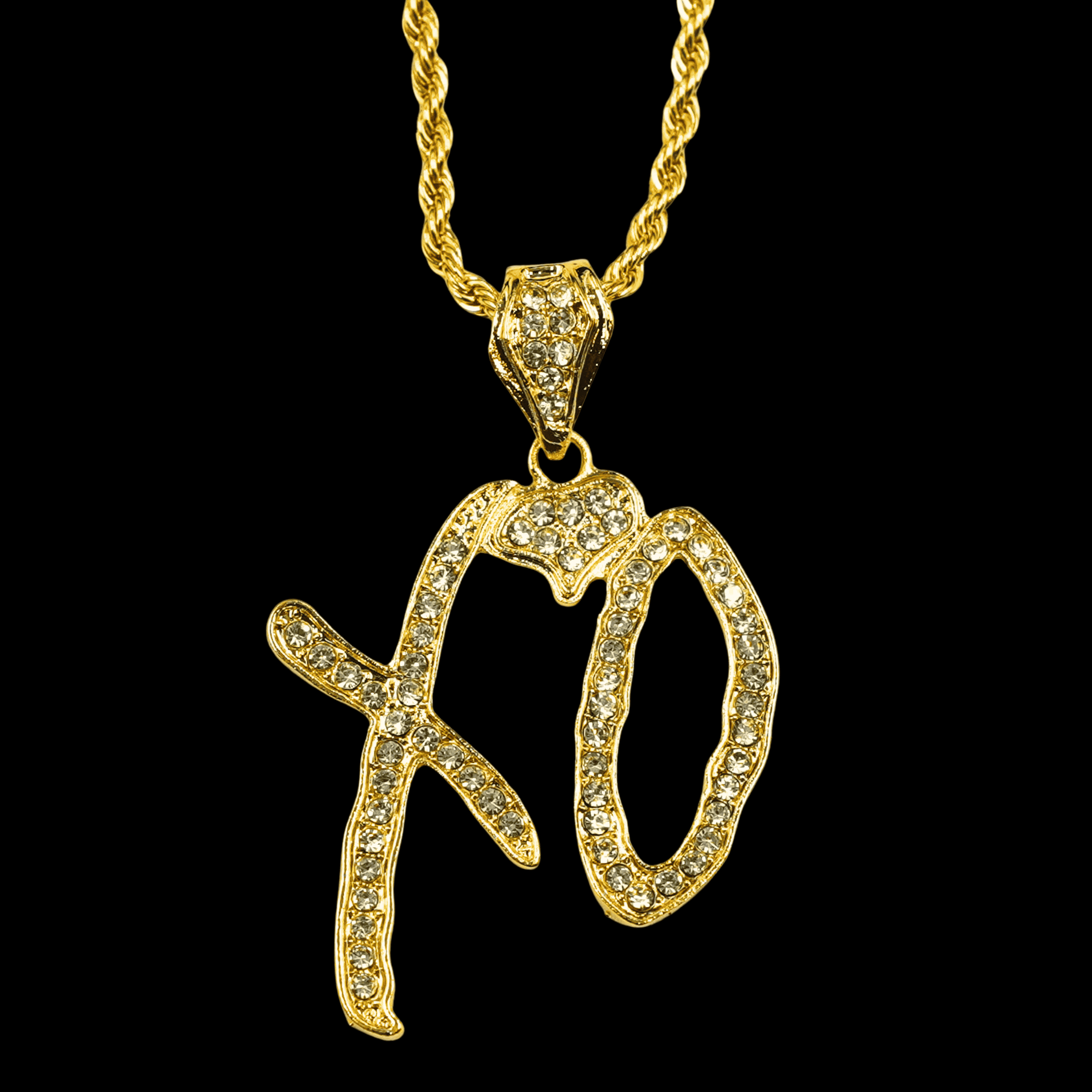 Gold pendant with 'XO' letters on a black background