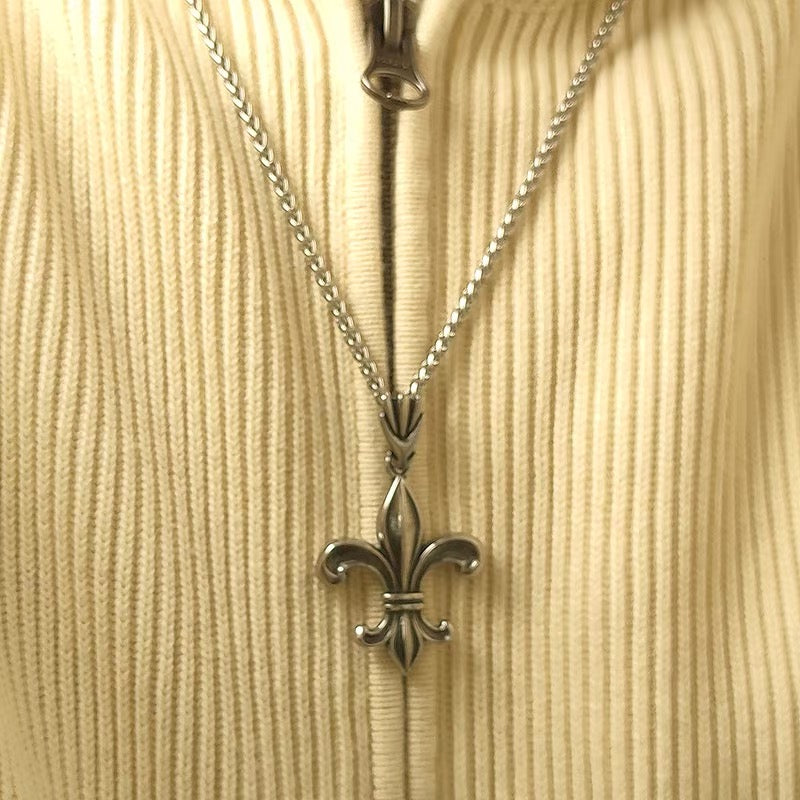 Iris Crest Pendant Necklace real photo worn over a cream knit top