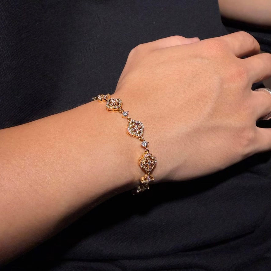 Gold-tone Crystal Quatrefoil Link Bracelet worn on wrist
