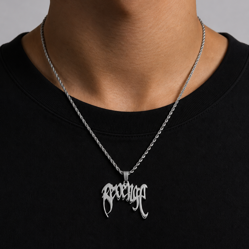Person wearing a black shirt with a silver Revenge necklace featuring a pendant.